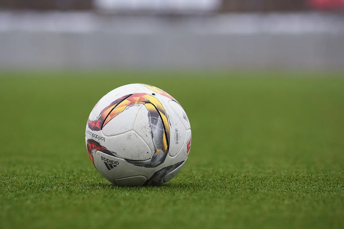 Soccer ball on grass pitch at youth soccer field