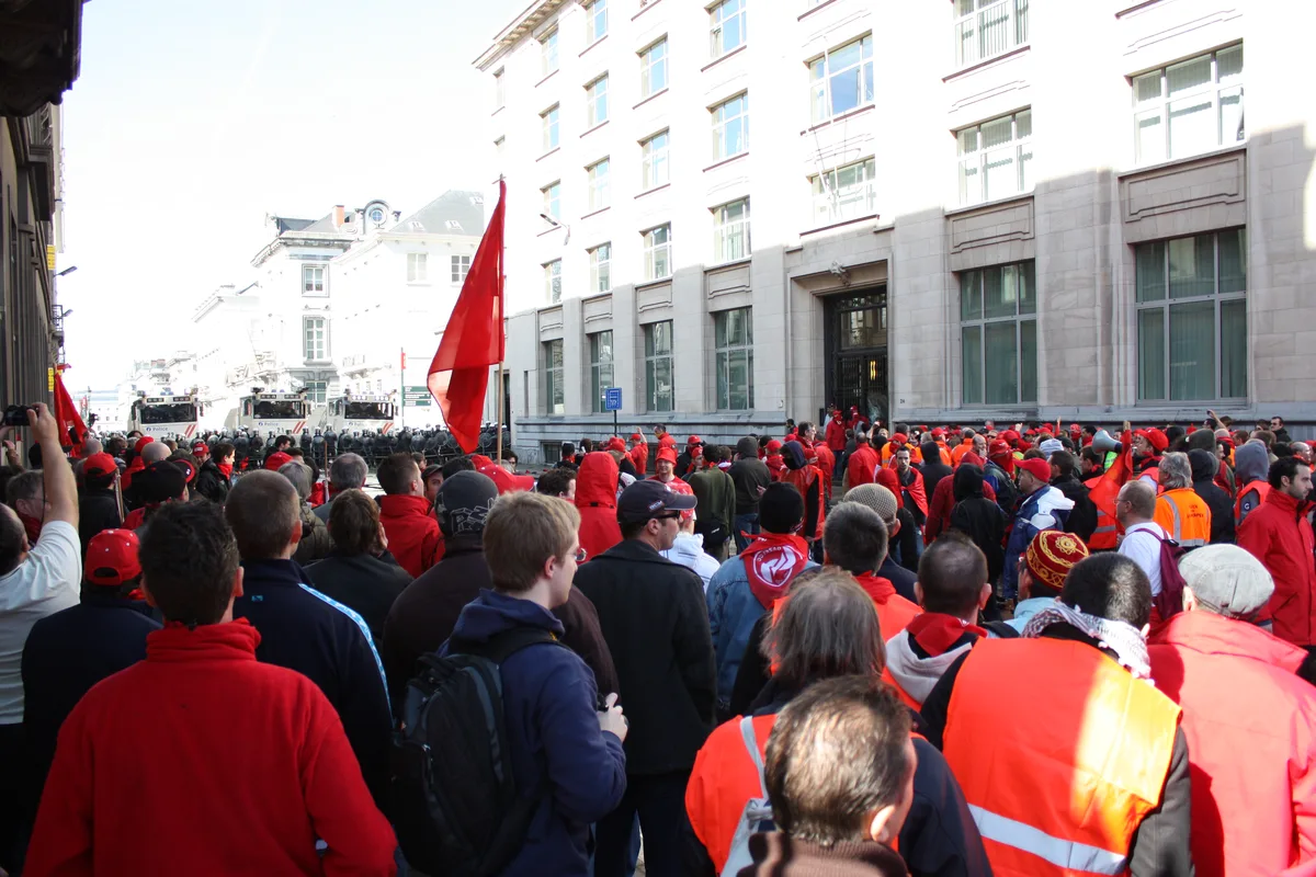 Crowd of protesters marching through Brussels with police nearby