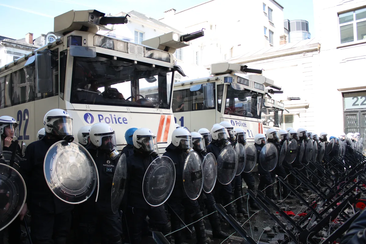 Riot police with shields and water cannon during the Brussels protest